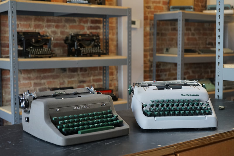 Photo of two Mid-Century American Portable Typewriters, the 1955 Royal Quiet De Luxe and the 1956 Smith-Corona Silent