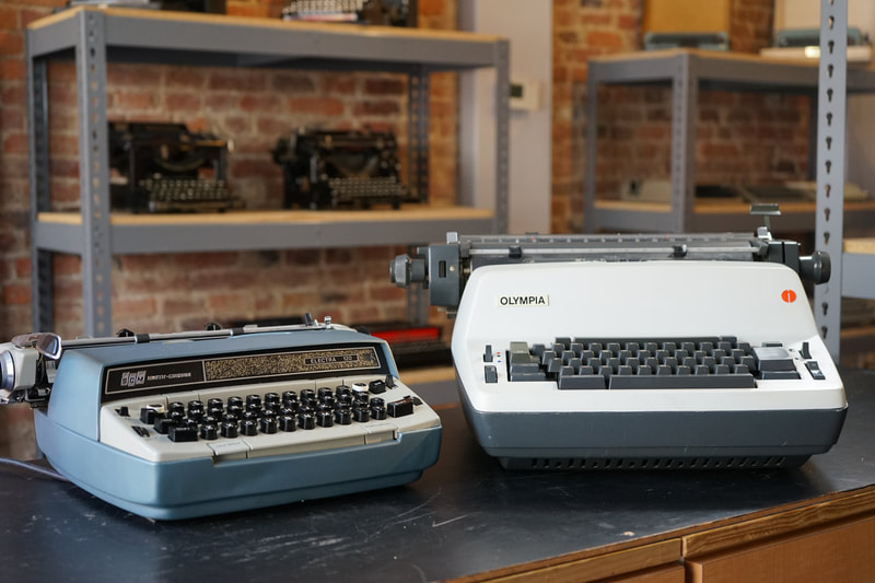 Photo of two electric typewriters, the 1968 Smith-Corona Electra 120 and the 1974 Olympia SGE A62